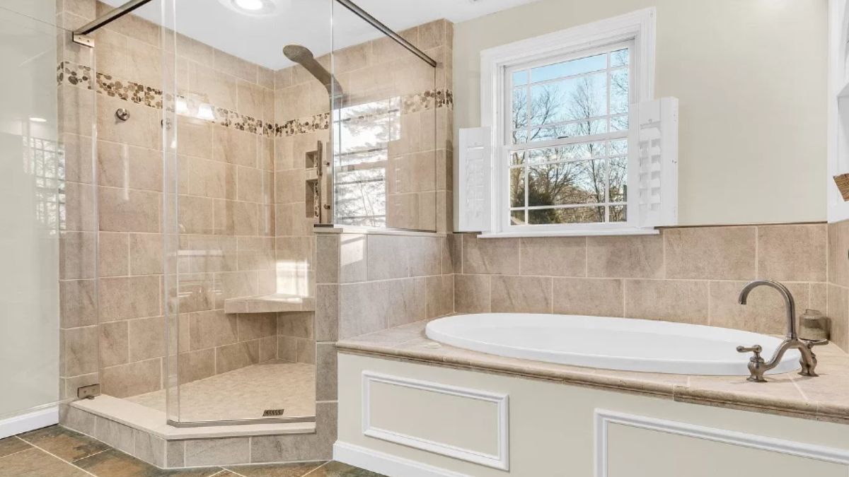 A bathroom with a bathtub and shower room.