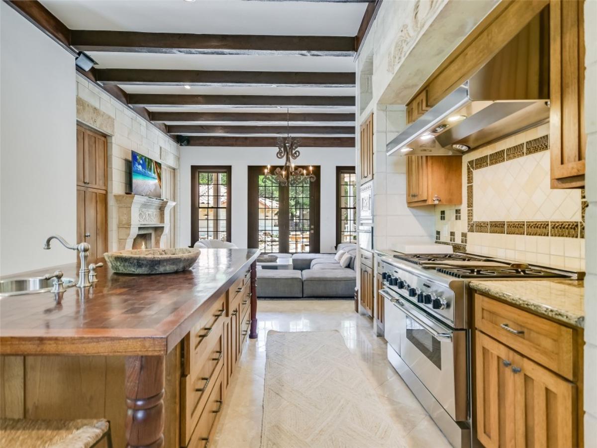 Kitchen with stainless steel appliances and center island prep area.