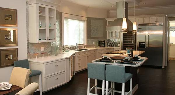 Kitchen with white cabinets and a center island with bar seating.