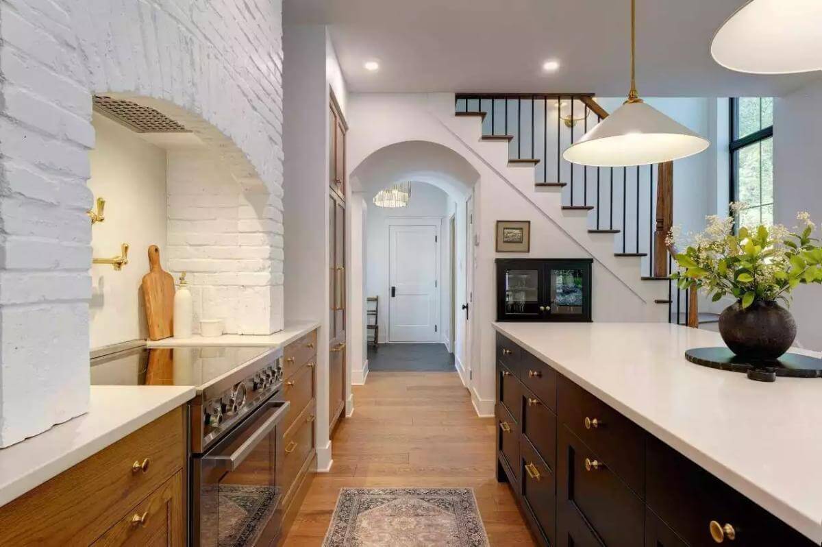 Kitchen showcasing the cooking alcove with painted bricks.