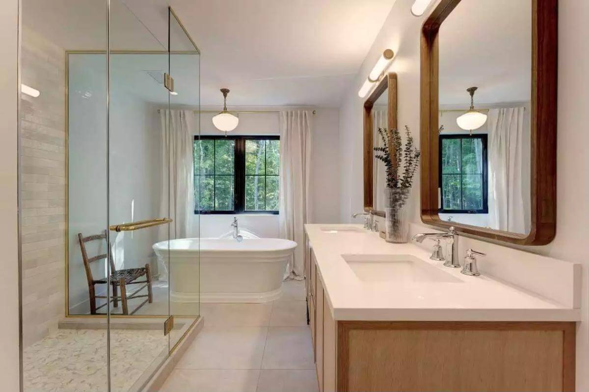 Primary bathroom with a dual sink vanity, a soaking tub, and a walk-in shower.