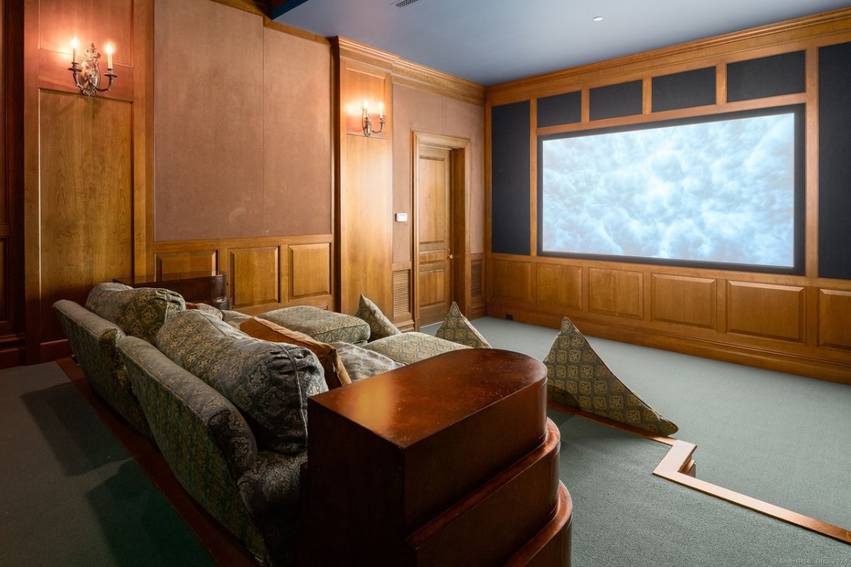 A home theater with a couch and a large screen.