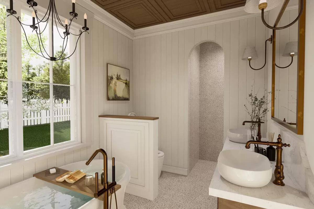 Bathroom with a soaking tub, a toilet area, and a large vanity with two vessel sinks and a wooden-framed mirror.