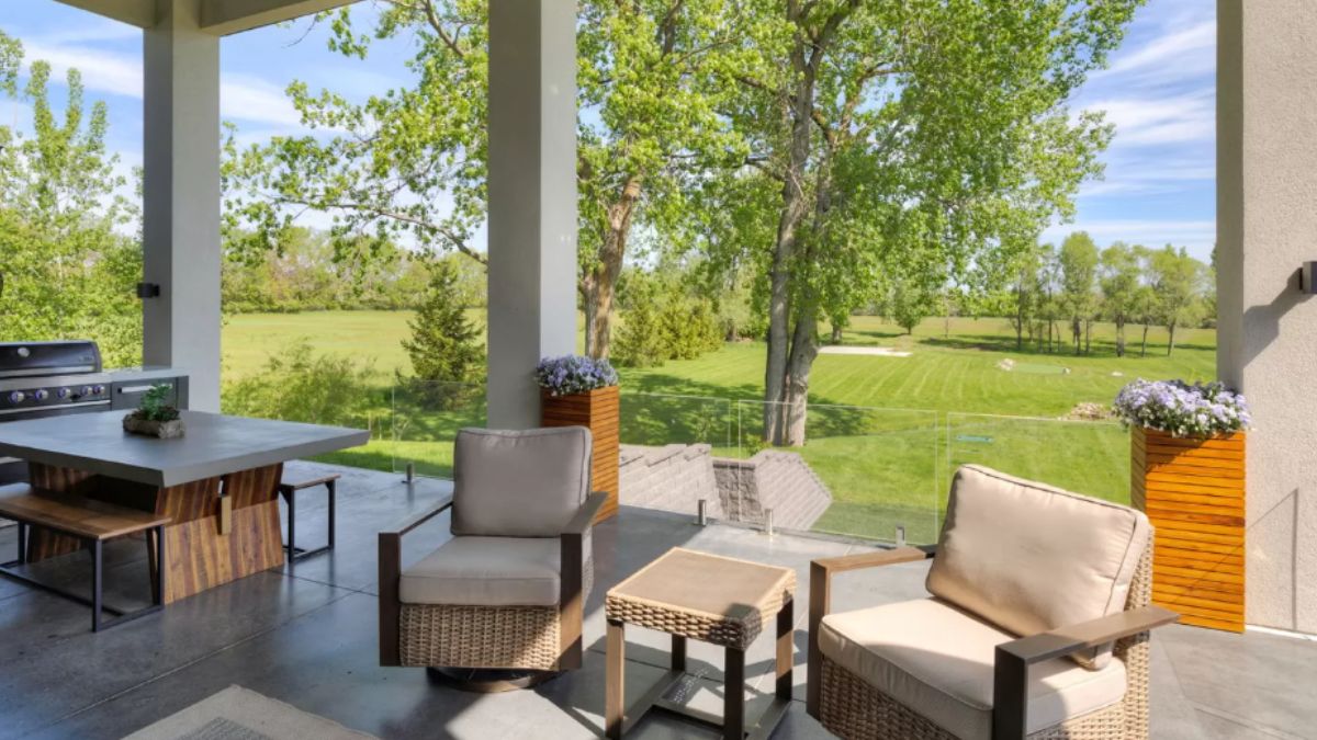 A porch with chairs, coffee table, and dining table.