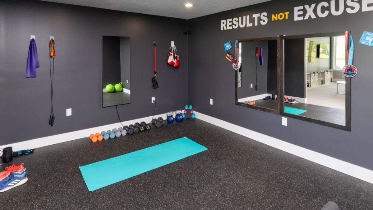 A home gym with mirrors and dumbbells.