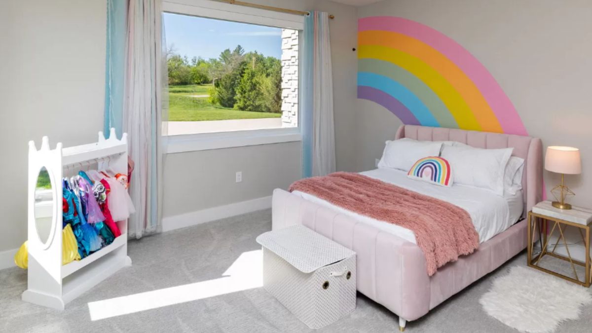 A kid's bedroom with a bed, window, and nightstand.