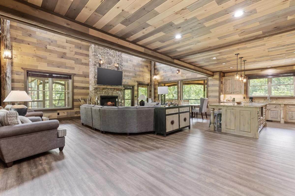 An open layout view of the living room, kitchen, and dining area.