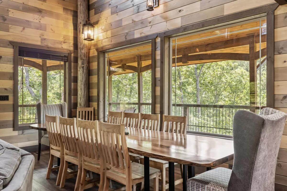 Dining area with a rectangular dining set surrounded by wooden and wingback chairs.