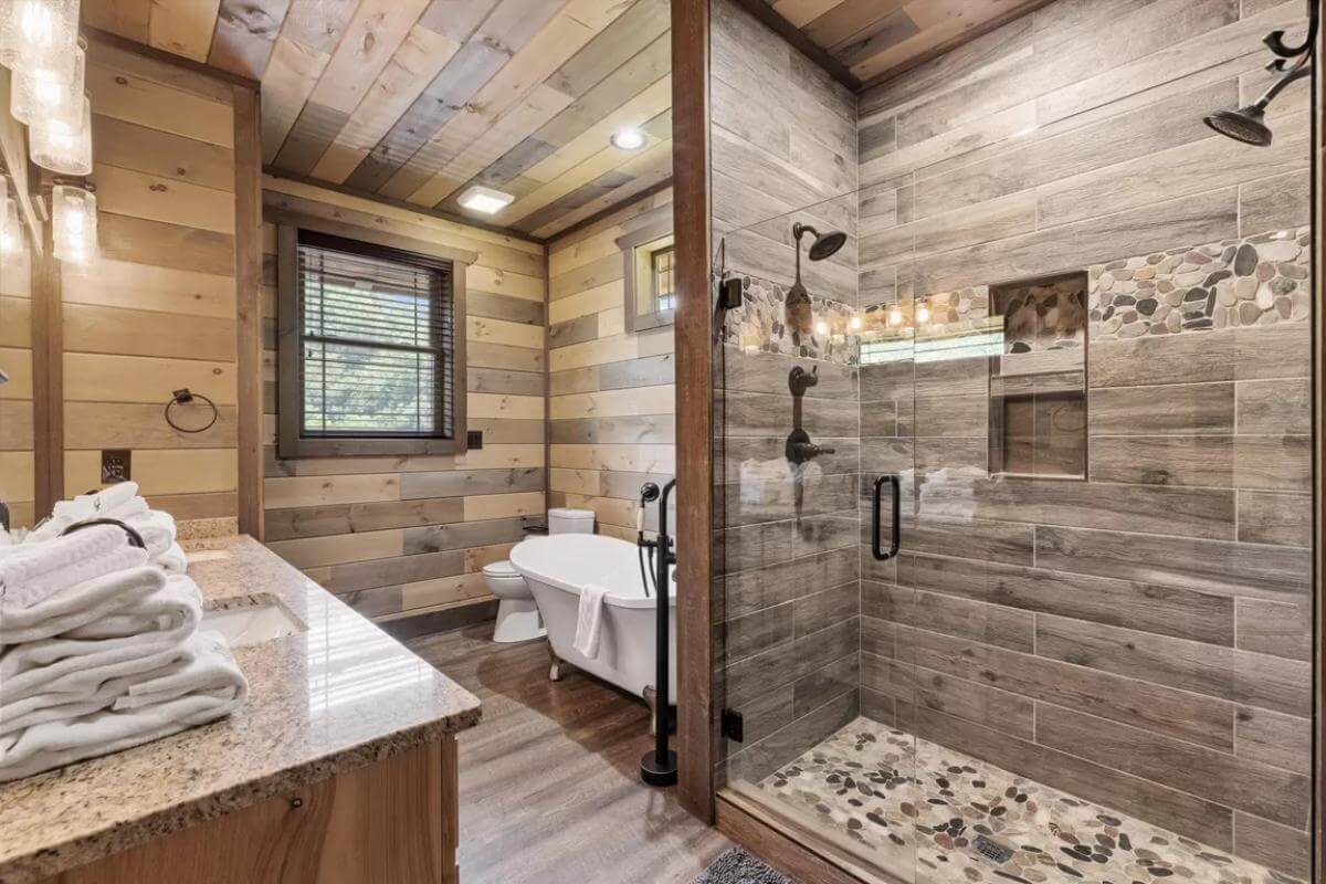 Primary bathroom with a sink vanity, a clawfoot tub, and a walk-in shower.