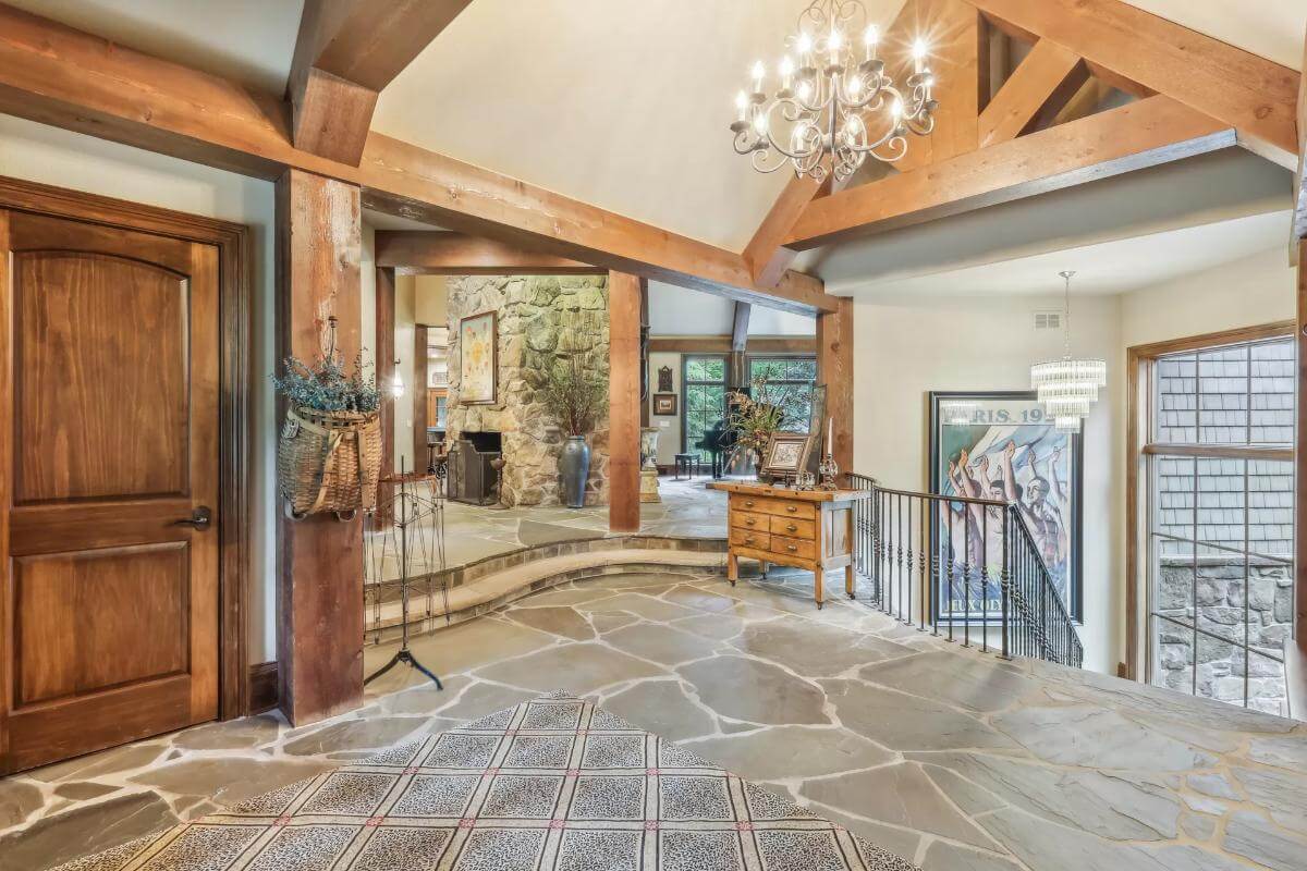 Foyer with a flagstone flooring and an ornate chandelier hanging from the cathedral ceiling.