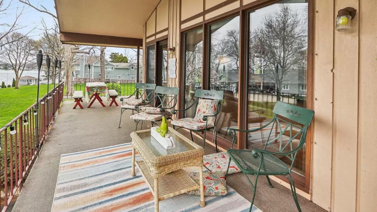 A terrace with a table, benches, chairs, and a coffee table.