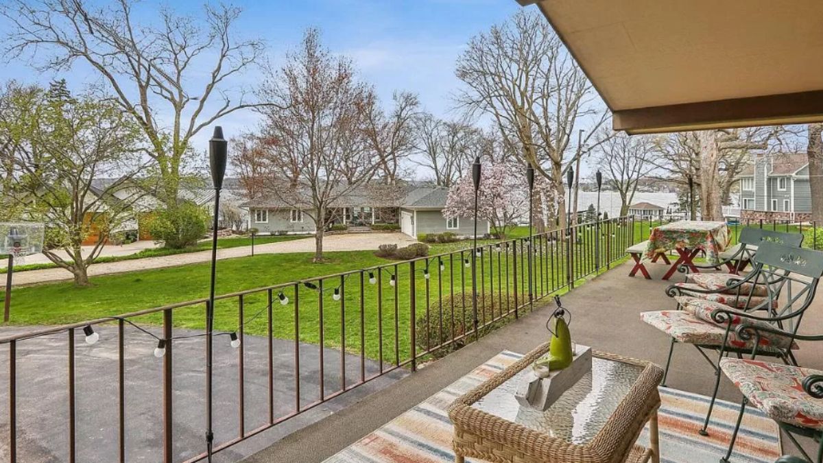 A terrace with a table, benches, chairs, and a coffee table.