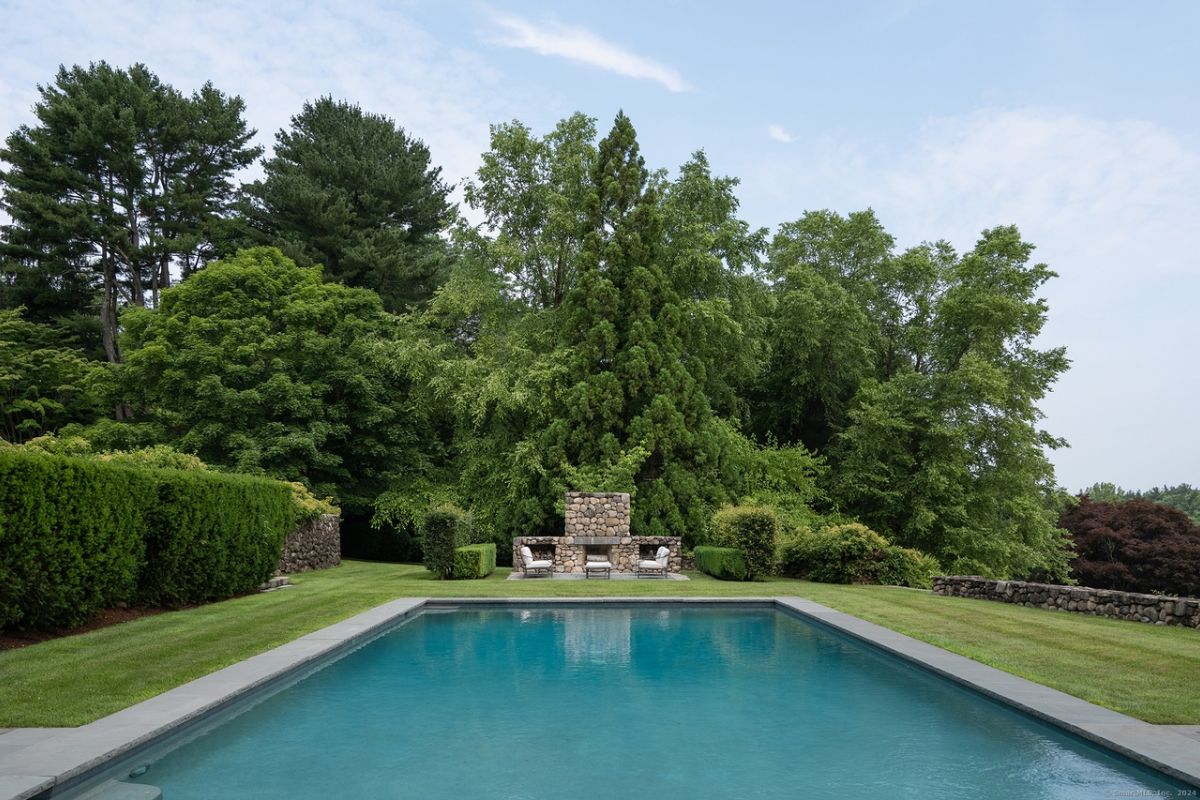 A swimming pool surrounded by trees.