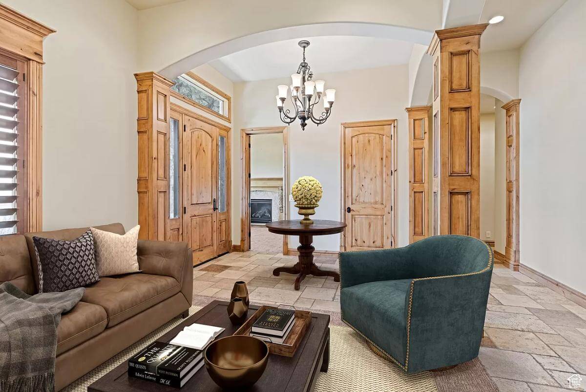 Sitting room with velvet seats and a dark wood coffee table.