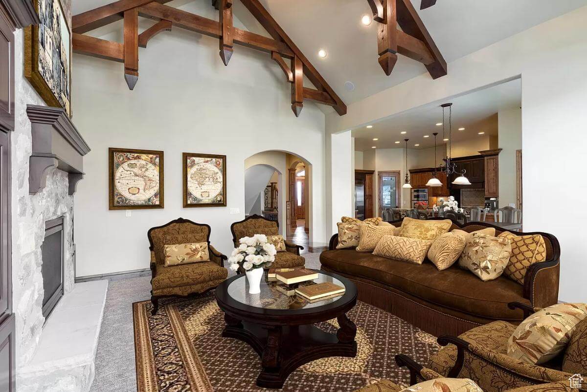 The living room includes a round coffee table over the brown area rug.