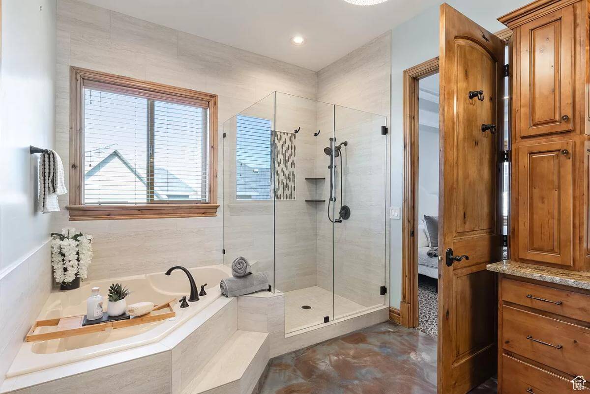 The primary bathroom includes a walk-in shower and a corner bathtub.