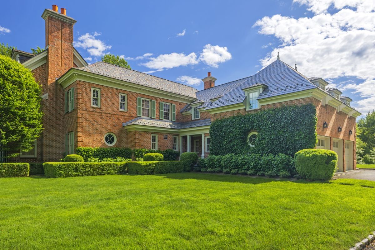 A lawn with green grass, plants, and trees.