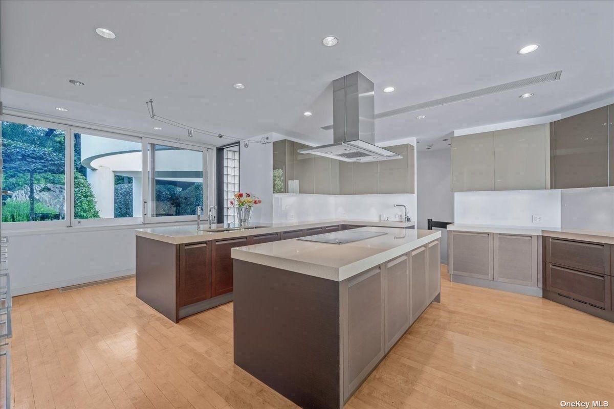 A kitchen with a center island, countertops, and cabinets.