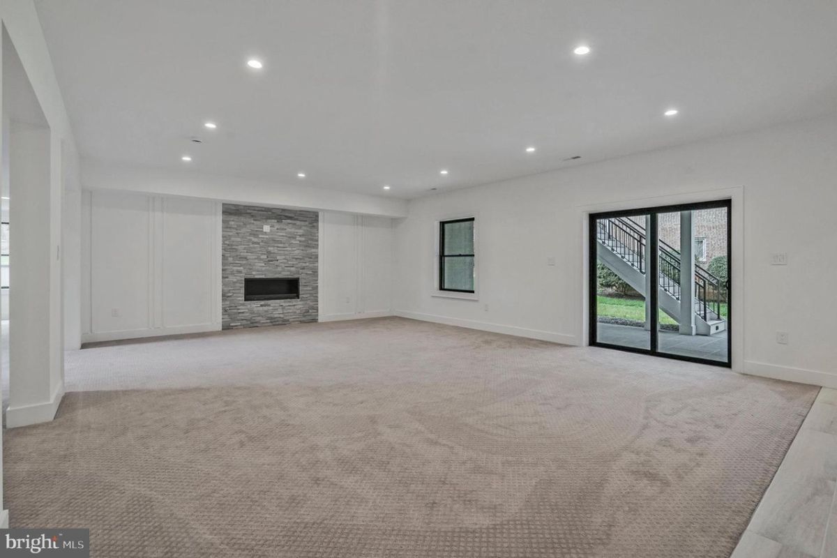 An empty room with a fireplace.