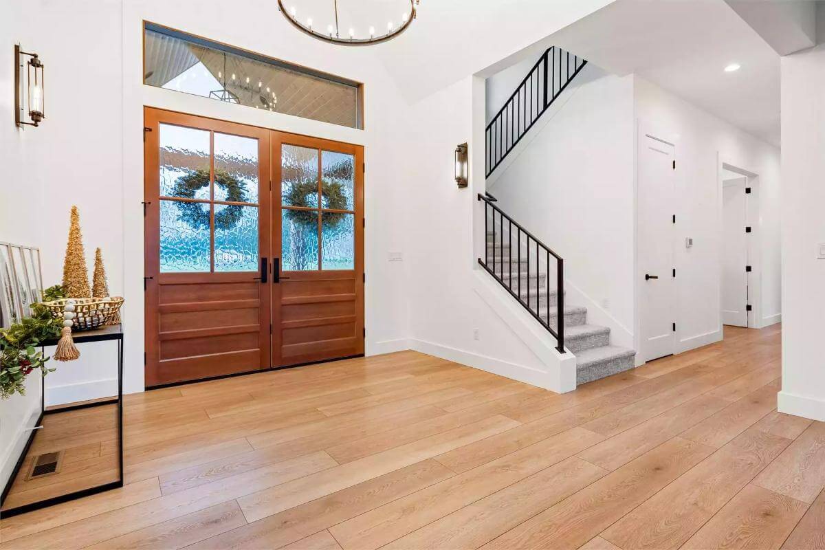 Foyer with a French front door and a staircase leading to the upstairs bedrooms.