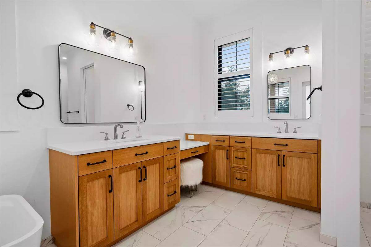 HIs and her vanities connected by a makeup counter.