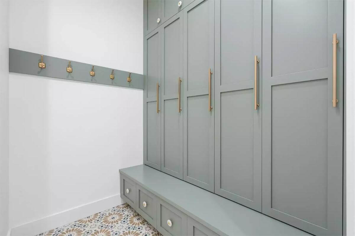 Mudroom with floor-to-ceiling cabinets and coat hooks.