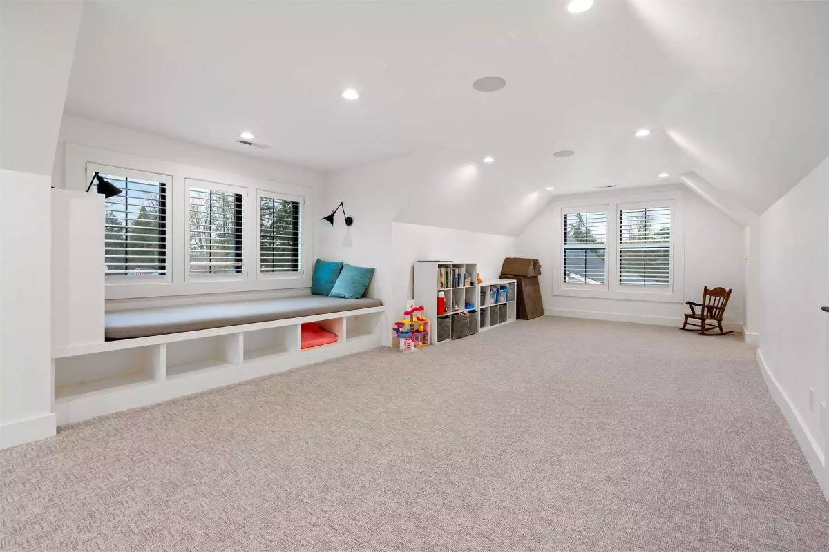 Bonus room with a window seat, a vaulted ceiling, and a carpeted floor.