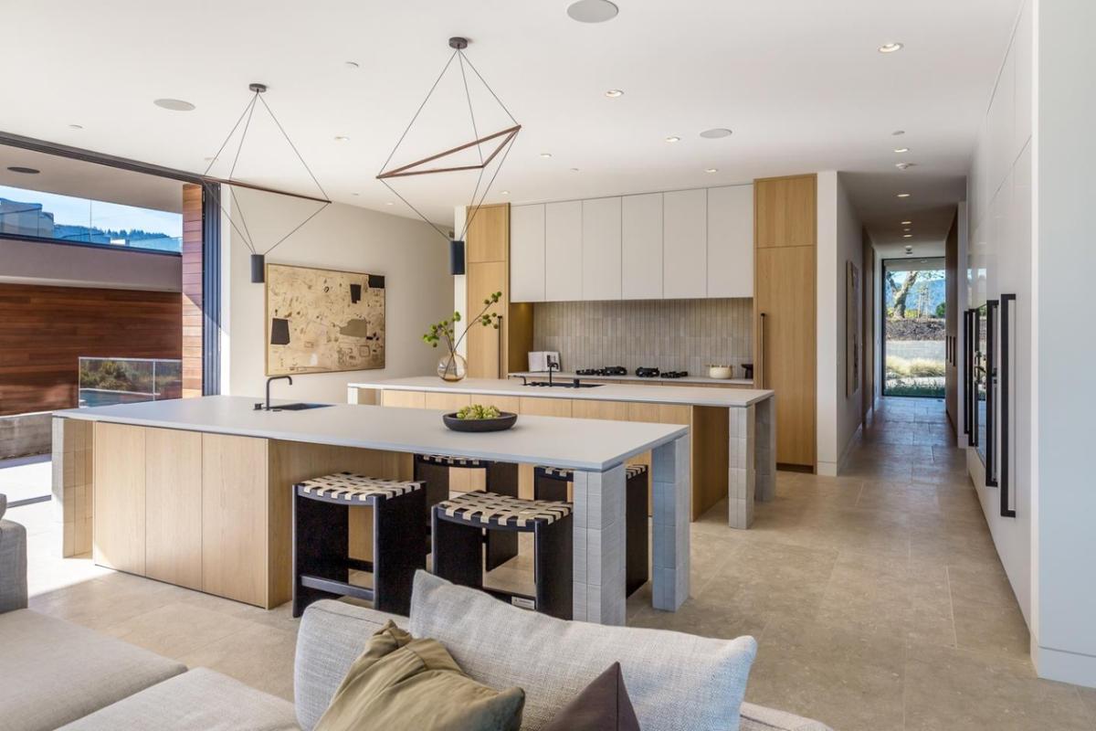 Kitchen with custom cabinetry, a counter breakfast bar and a center island prep area.