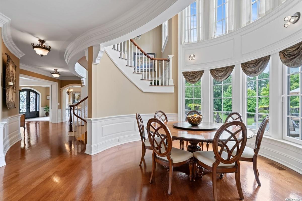 Breakfast nook with a round wood table.