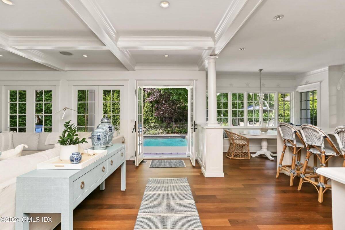 Hallway with a gray console table and a French door that opens to the backyard.