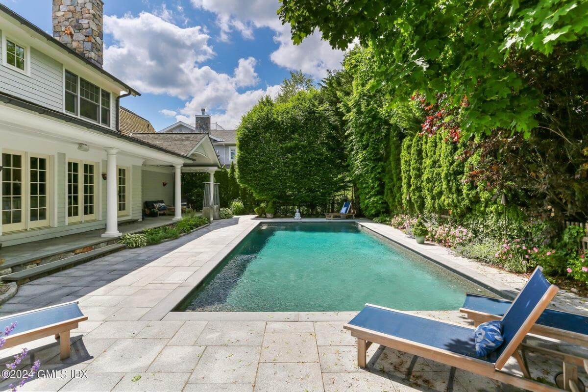 Pool area surrounded by lush plants.