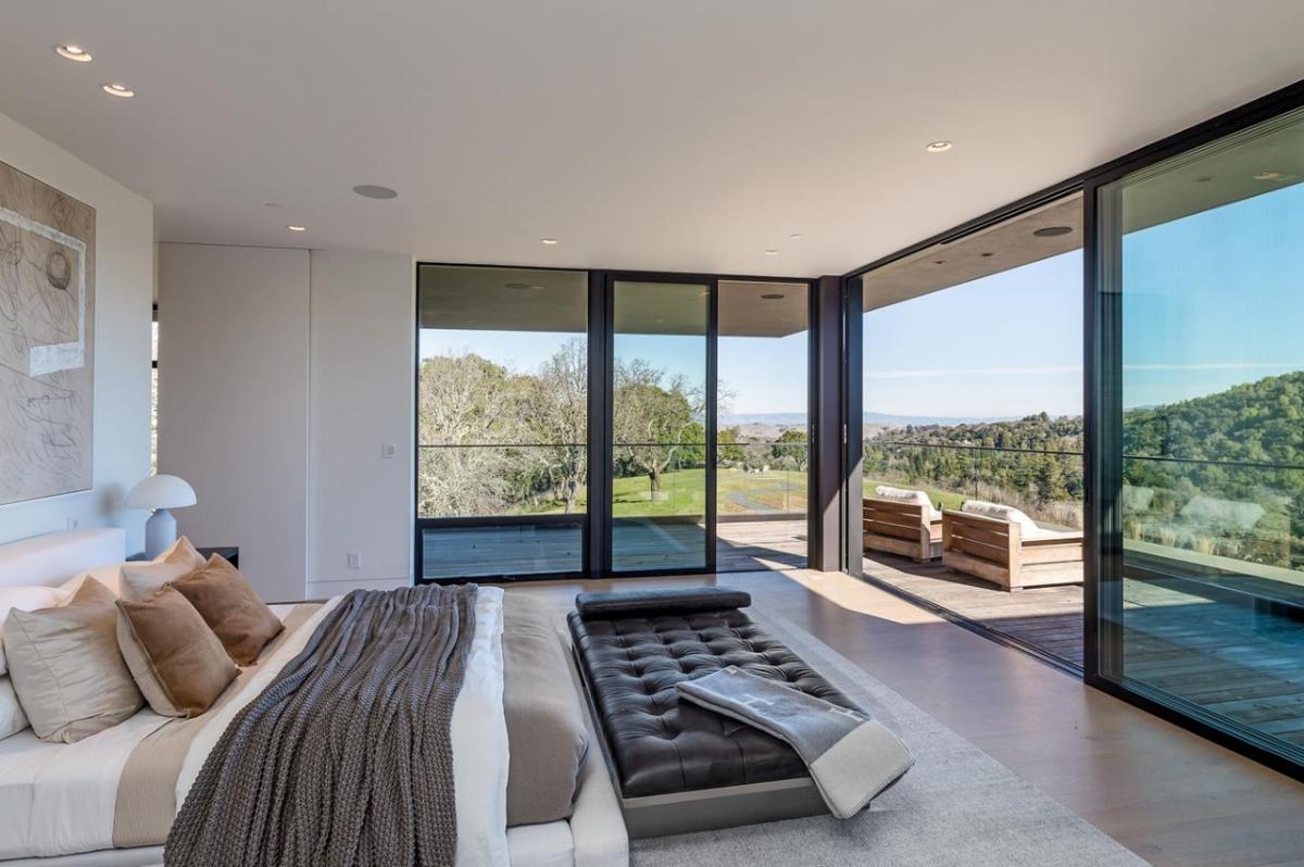 Bedroom with hardwood floors and sliding glass doors.