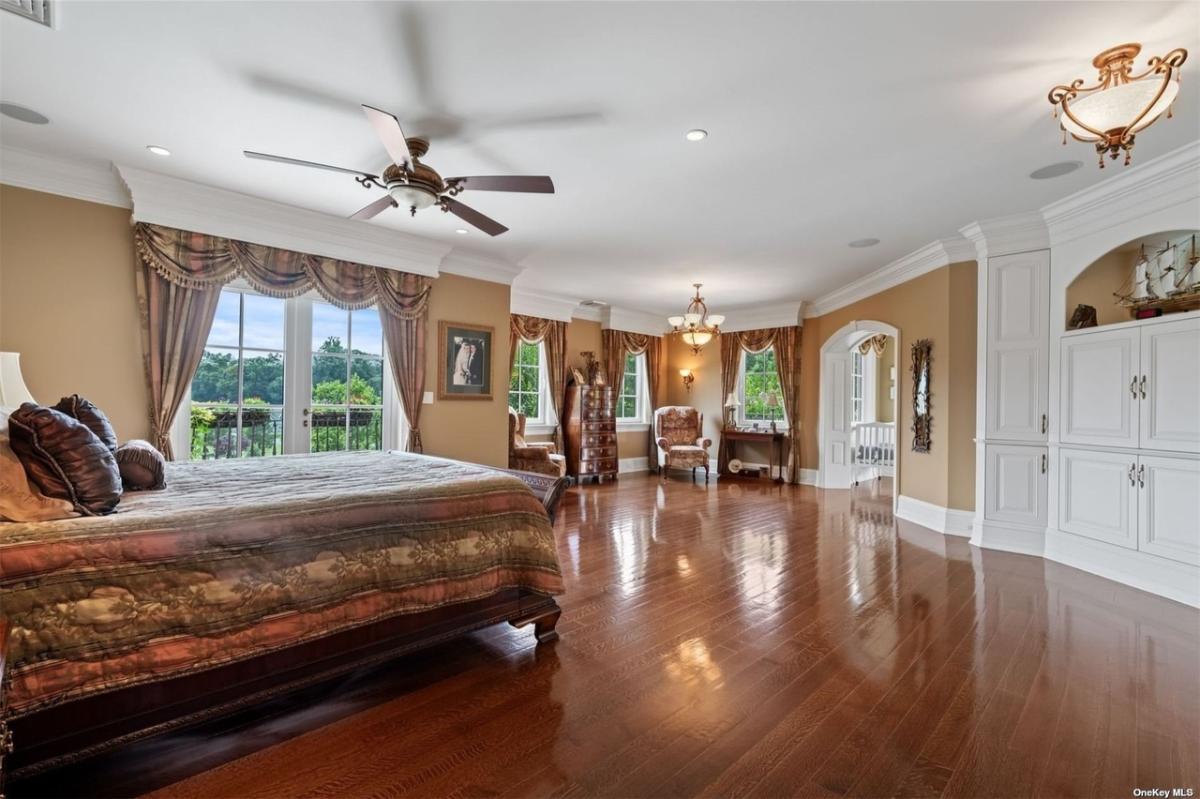 Bedroom with a large bed and hardwood floors.