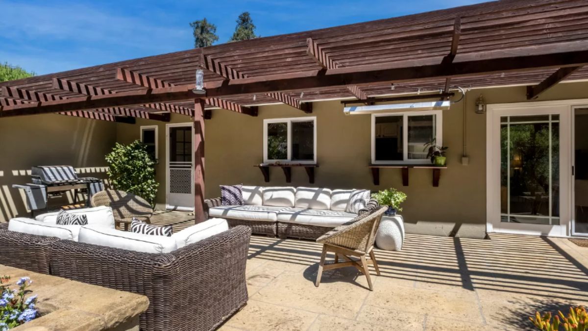 A patio with couches, chairs, and plants.