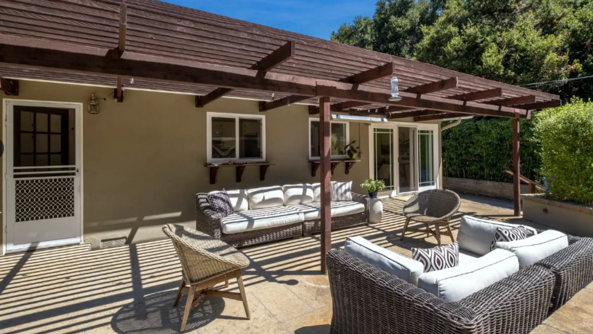 A patio with couches, chairs, and plants.