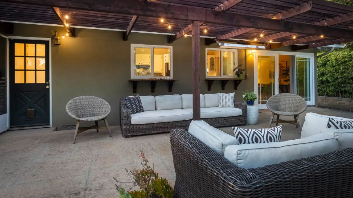 A patio with couches, chairs, and plants.