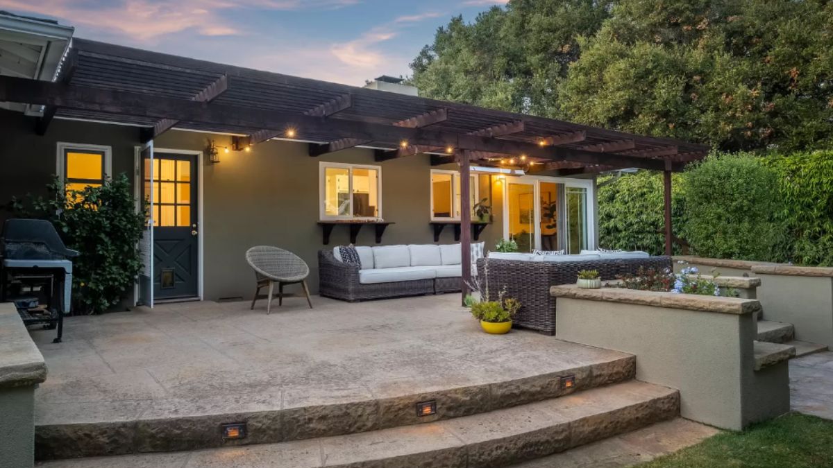 A patio with couches, chairs, and plants.