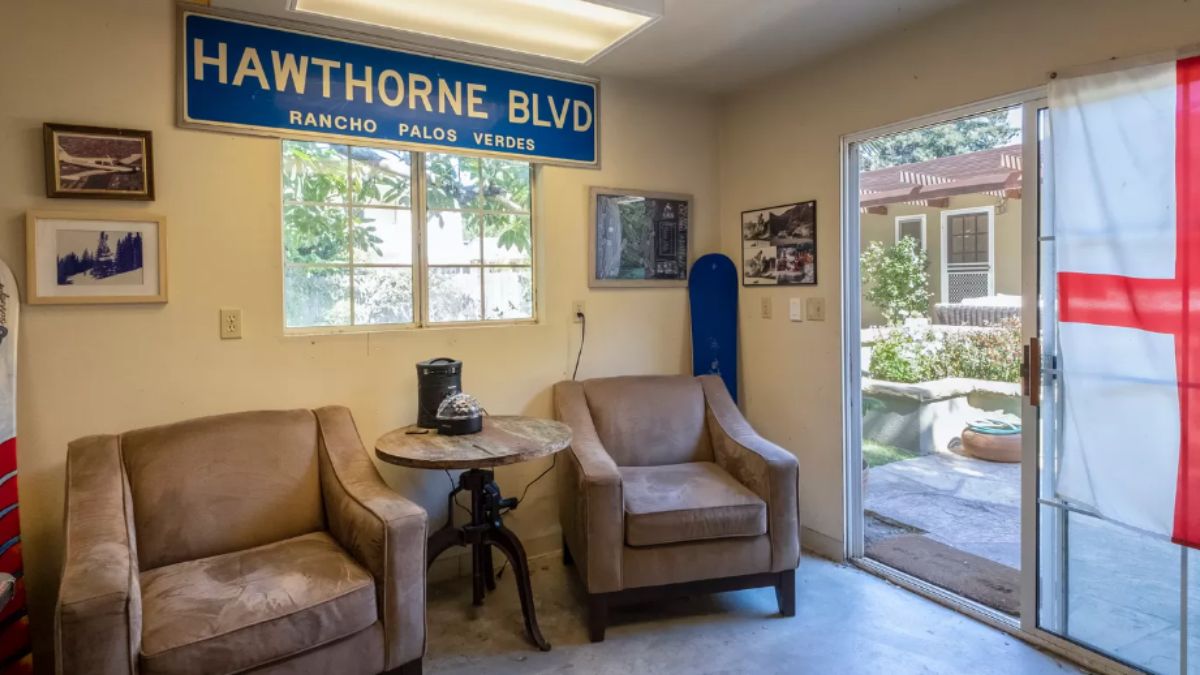 A bonus room with windows, chairs, and a coffee table.