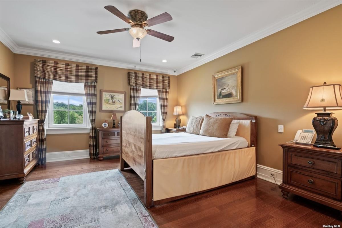 Bedroom with hardwood floors and glass windows.