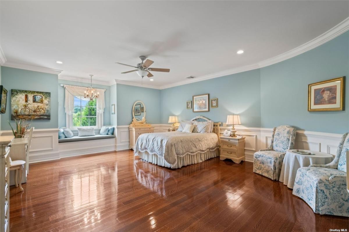 Bedroom with hardwood floors and glass windows.