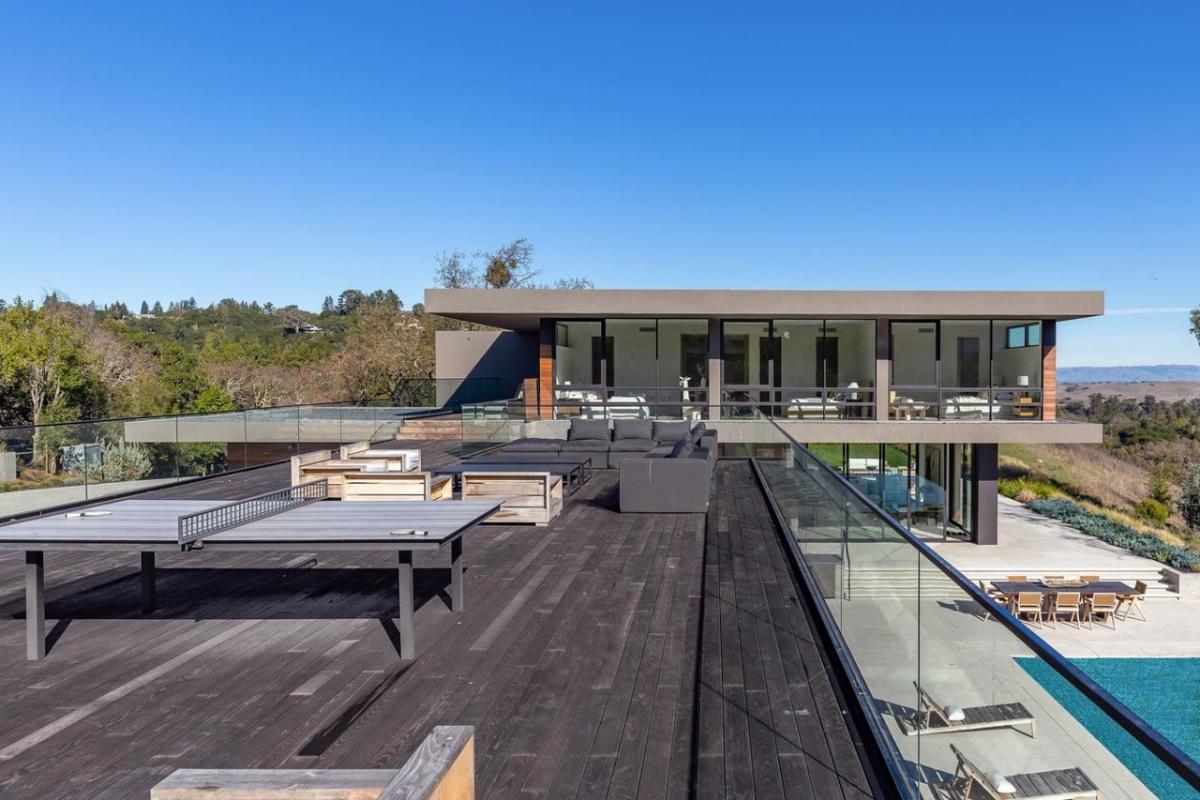 Rooftop deck with a living space and a table tennis.