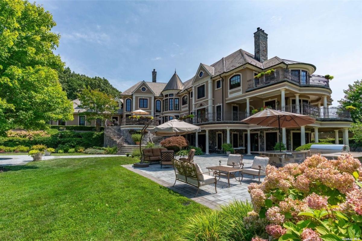 Rear view of the mansion with a patio.