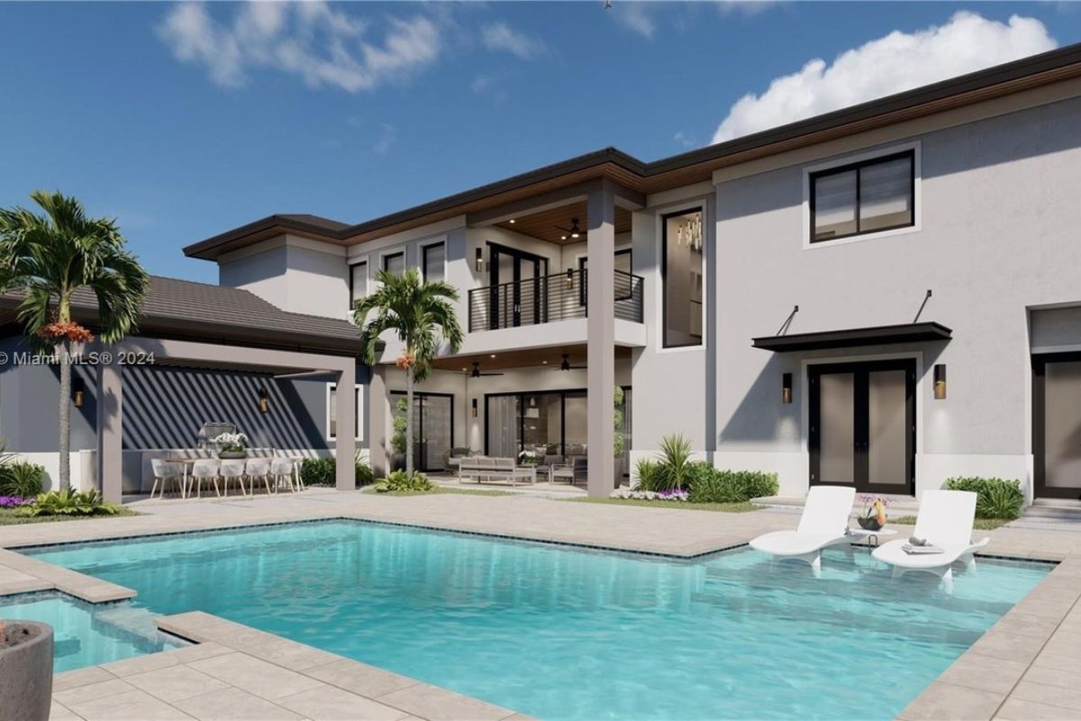 A swimming pool with a jacuzzi and comfy chairs.