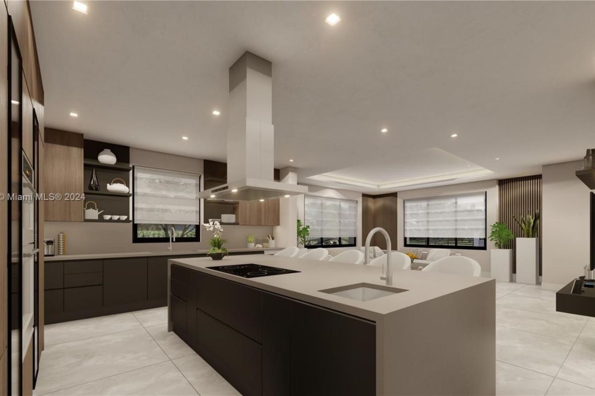 A kitchen with countertops, chairs, a sink, and cabinets.