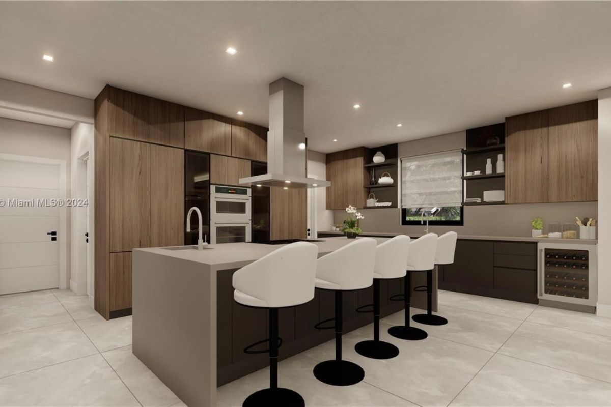 A kitchen with countertops, chairs, a sink, and cabinets.