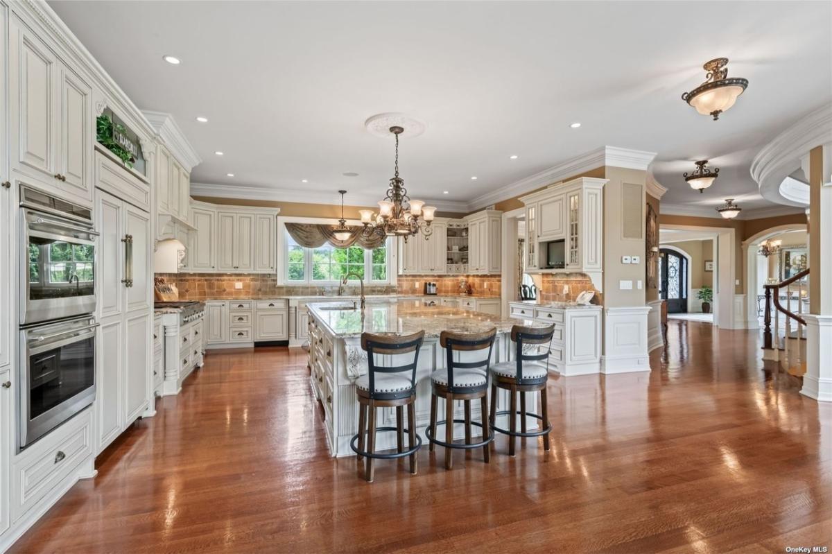 Kitchen with custom cabinetry and a counter breakfast bar.