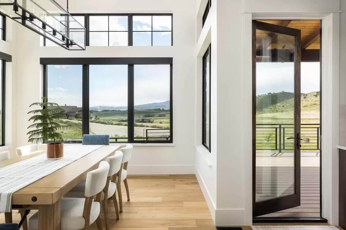 Dining area with a contemporary dining set and a glazed door that opens to a covered patio.