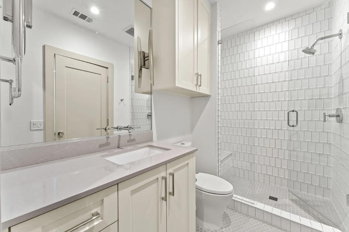 Bathroom with a sink, toilet and a walk-in shower.