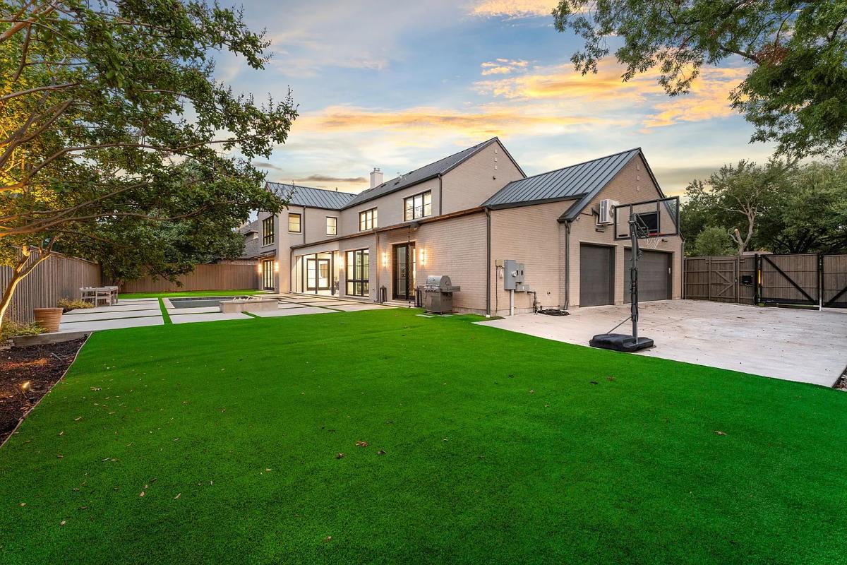 Backyard of the mansion with a pool and a basketball court.