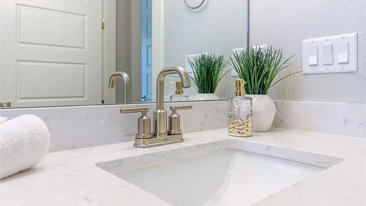 A bathroom with a vanity and mirror.